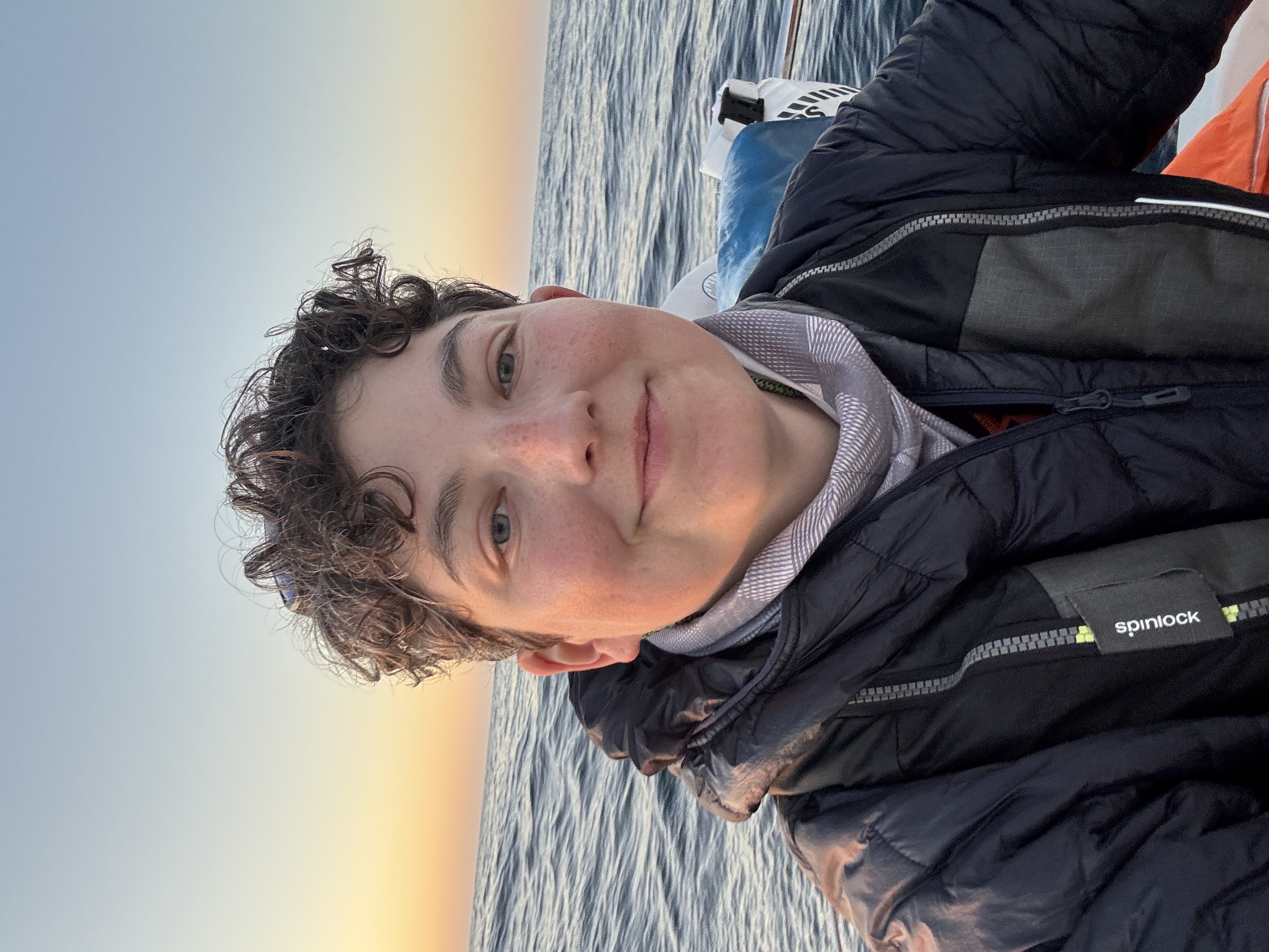 Photo of crewmember headshot in front of water